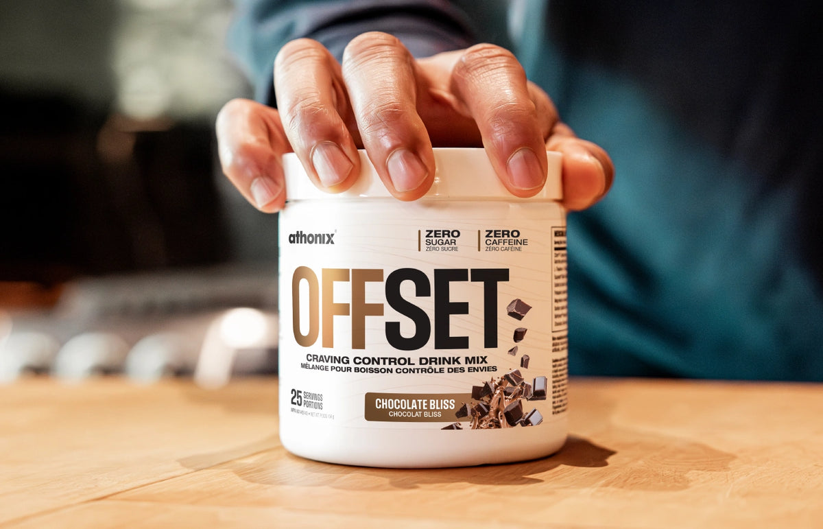 Hand grabbing the lid of an Athonix OFFSET Chocolate Bliss bottle