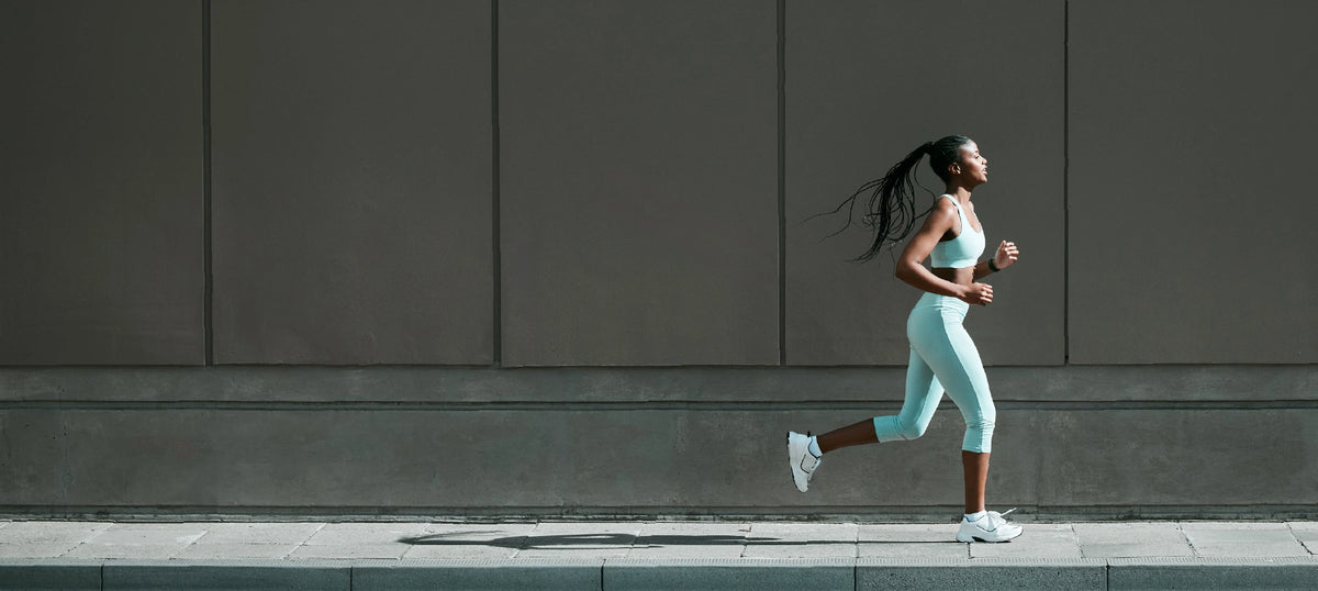 Woman running along a sidewalk