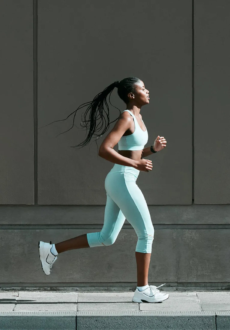 Woman running along a sidewalk