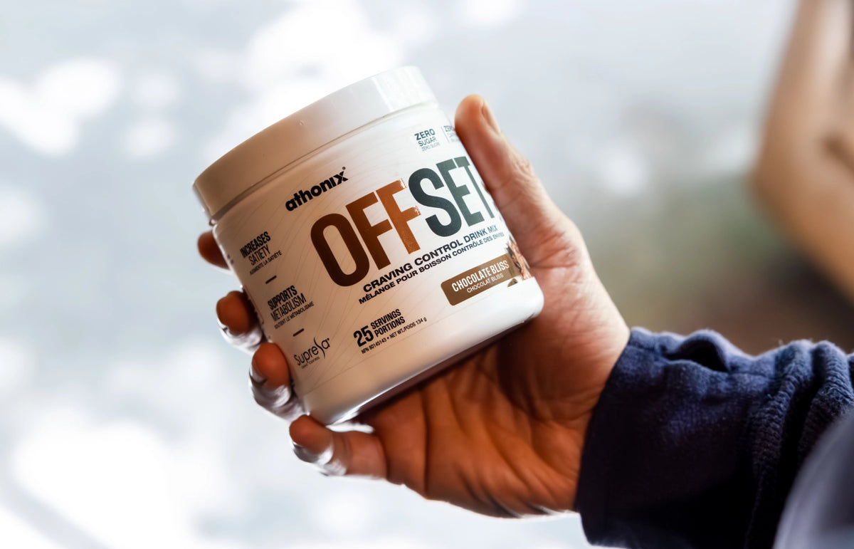Hand holding a bottle of Athonix OFFSET Chocolate Bliss