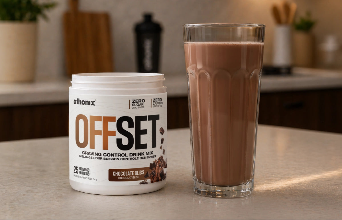Clear glass of Athonix OFFSET Chocolate Bliss beside an open bottle in a kitchen