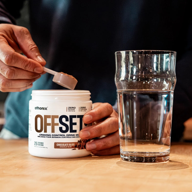 Scoop of Athonix OFFSET Chocolate Bliss powder being lifted from the bottle