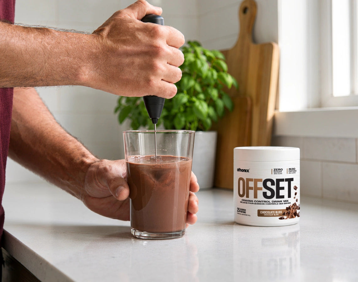 Athonix OFFSET Chocolate Bliss being mixed in a clear glass with a frother
